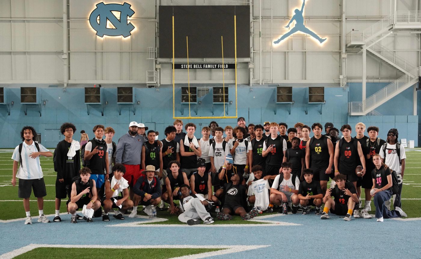 The 2026 College Bus + Camps TOUR group at UNC's indoor practice facility