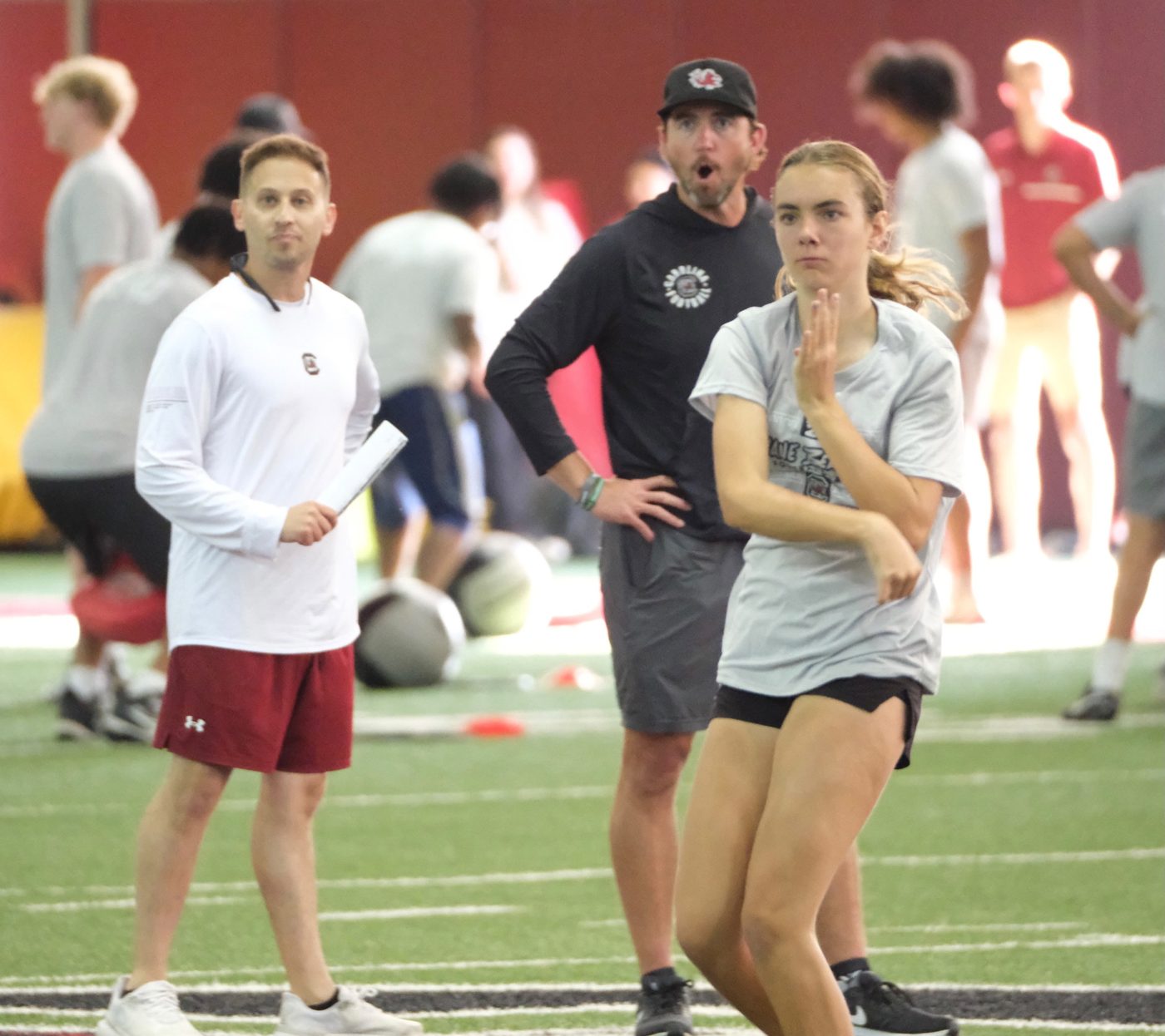 South Carolina's offensive coordinator reacts in surprise after a throw by Kennedy Ford at camp
